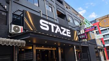 A building with a large sign reading 'STAZE' and another sign for 'N.R.U Massage'.