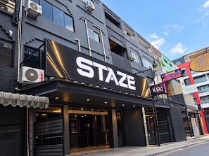 A building with a large sign reading 'STAZE' and another sign for 'N.R.U Massage'.