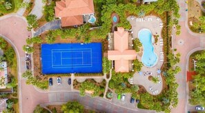 An aerial view of a resort with a tennis court, swimming pool, and landscaped areas. - Luxury Coastal Retreat/Private Pool/Lanai/Fire Pit/ Community Pool (Destin)