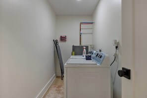 A laundry room with a washing machine, a dryer, and a first aid kit on the wall. - The Wine House •4 Wineries • Fenced Yard •Fire pit (Ellijay)