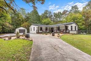 A two-story house with a covered porch and a garage. - The Wine House •4 Wineries • Fenced Yard •Fire pit (Ellijay)