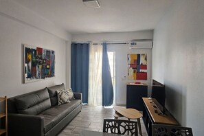 A modern living room with a sofa, a coffee table, and artwork on the walls. - 3 apartments for up to 14 guests in Estoril beach (Sal Rei)