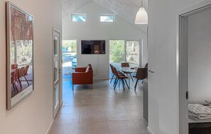 A spacious interior with a dining area, a sofa, and a TV mounted on the wall. - Stunning home in Ulfborg with WiFi (Ulfborg)