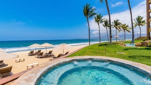 A resort pool with a view of the ocean and palm trees. - Luxury 2BR Villa at Villa La Estancia – Stunning Views, Infinity Pools & Spa (Nuevo Nayarit)