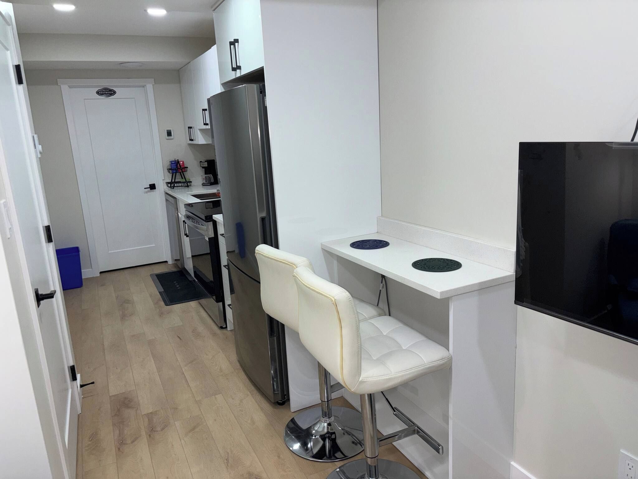 A compact kitchen with a refrigerator, a microwave, and a small countertop.