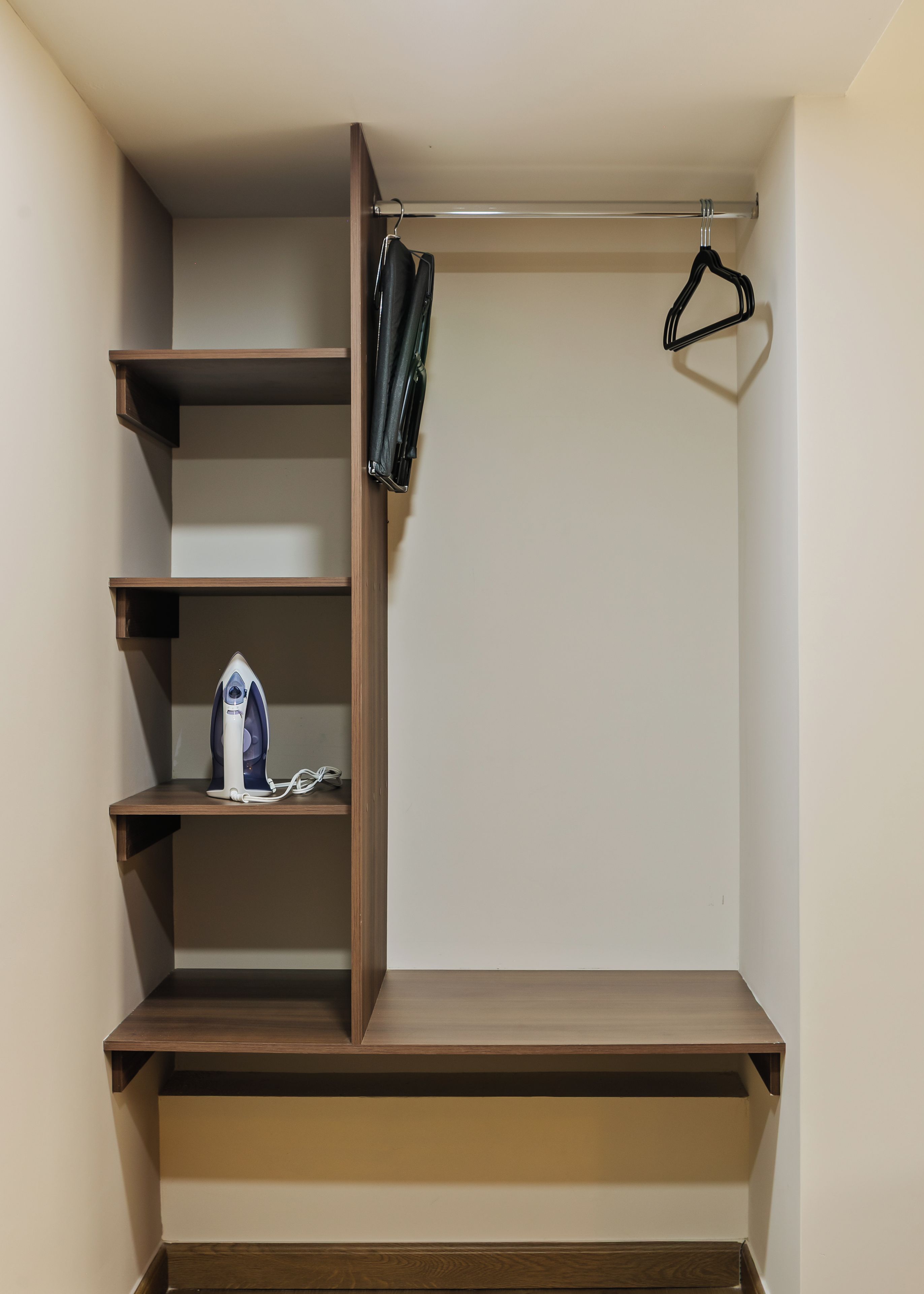 A walk-in closet with multiple shelves and hanging space.