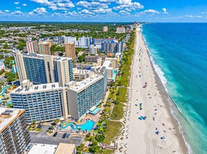 A coastal hotel with multiple buildings, a beachfront, and a swimming pool. - Spacious 3BR Coastal Getaway at Sand Dunes (Myrtle Beach)