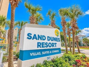 A sign for Sand Dunes Resort advertising villas, suites, and condos. - Spacious 3BR Coastal Getaway at Sand Dunes (Myrtle Beach)