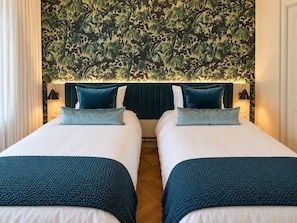 A double room with two beds, each with a white mattress and teal bedding. - Beachfront Retreat, Ocean Views & Boutique Luxury (George Town)