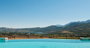 A swimming pool with a mountain backdrop. - Stunning Townhome Mountain Views and Amenities (Eden)