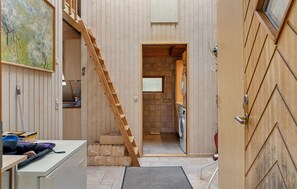 A narrow hallway with a wooden staircase leading to a laundry area. - Awesome home in Højby with WiFi (Højby)