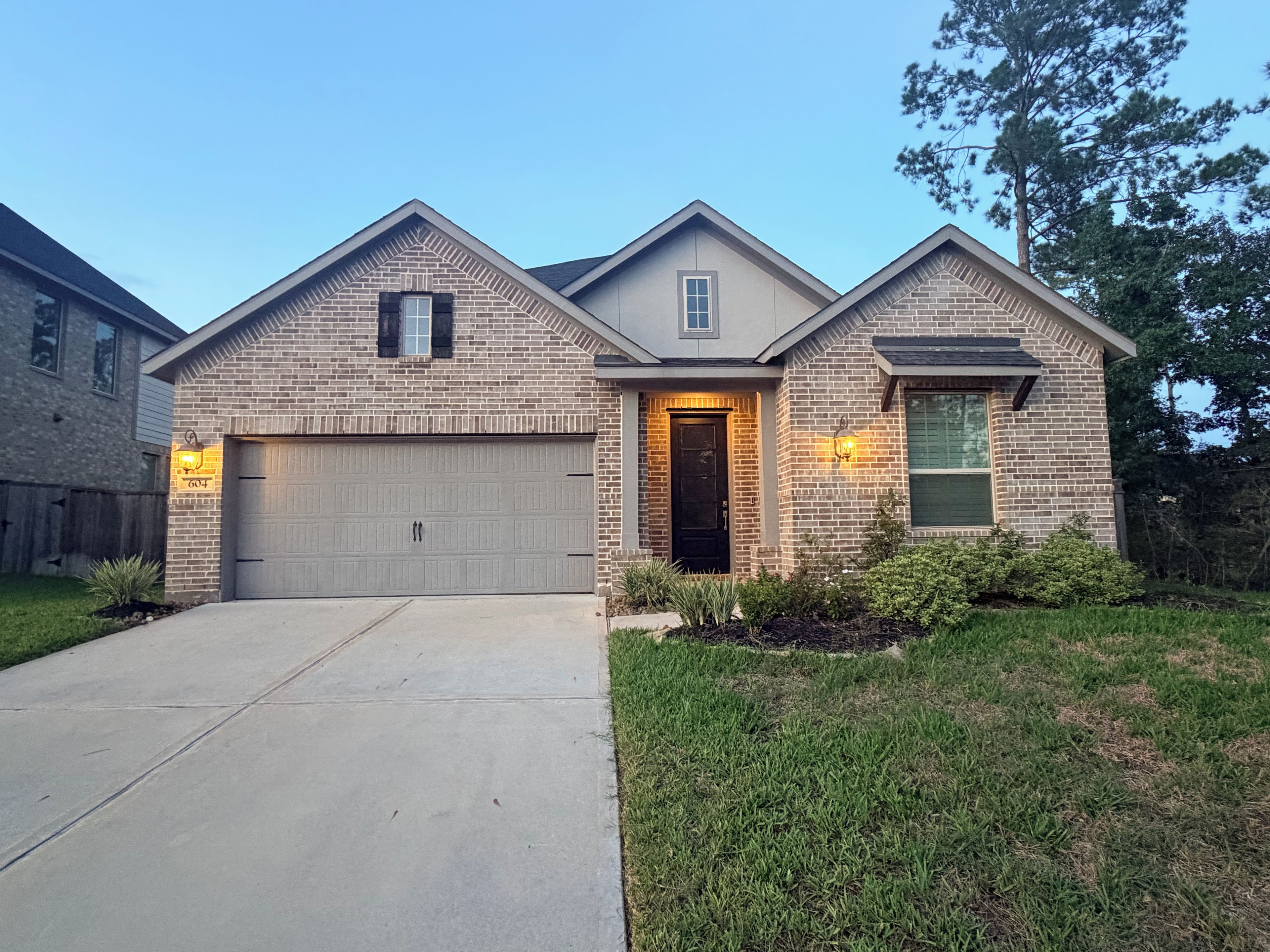 A two-story house with a garage, a front door, and a small window.