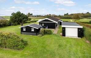 A residential property with a main house, a garage, and a smaller shed. - 3 bedroom stunning home in Bogense (Bogense)