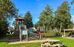 A playground with a slide, climbing structures, and a picnic table. - Nice home in Workum with WiFi (Workum)