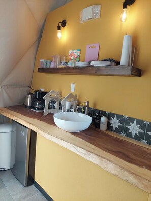 A kitchen with a white sink, a coffee maker, and a toaster on the counter. - Luxury Glamping Dome - 2 beds - with amazing Arenal Volcano and Lake views (El Castillo)