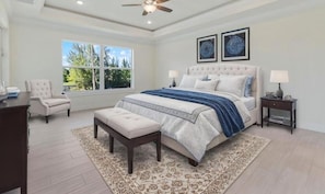 A bedroom with a large bed, a nightstand, a chair, and a window with a view of trees. - Villa Reflection-newly built on water, west facing, pool and spa (Cape Coral)
