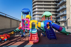 A children's play area with various colorful play structures. - Apartments Zarafshan city 5 Tashkent (Tashkent)