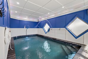 A swimming pool with a blue and white color scheme, a basketball hoop, and a window. - NEW Smoky Mountain Swim-Inn Private Pool, Arcade in Pigeon Forge Dog Friendly (Pigeon Forge)