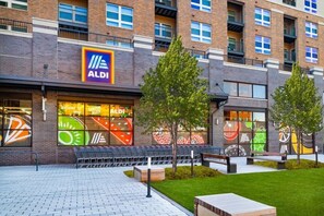 A multi-story building with a large storefront featuring a prominent ALDI sign.