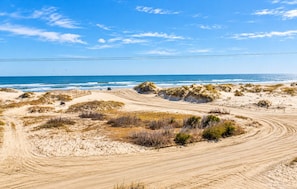 A sandy beach with dunes and a clear view of the ocean. - Resting Hearts - 4x4 Carova Beach, Ocean Views, Pool, Cargo Lift, Up to 4 Dogs OK, Flex Stays (Carova Beach)
