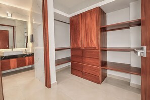 A modern bathroom with a vanity, mirror, and a wooden wardrobe with multiple compartments. - Villa Almarez | Private Luxury Retreat (Tulum)