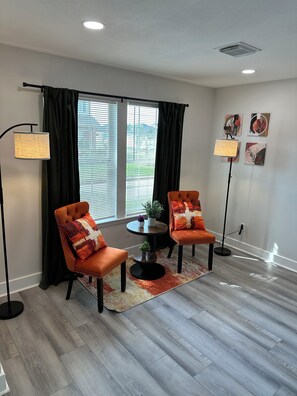 A modern living room with two leather armchairs, a round coffee table, and a floor lamp. - Huge Modern 4Bdr home-The Xperience #2 (Houston)