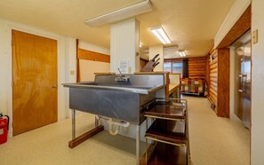 A kitchenette with a stainless steel sink, a wooden countertop, and a built-in oven. - The Lodge at Wapiti Valley Ranch- ideally located between Cody and Yellowstone (Cody)