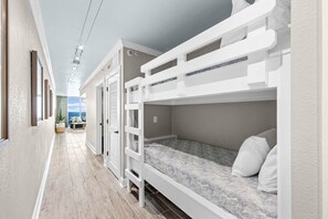 A room with bunk beds, a hallway, and a view of the ocean. - New Listing! Newly Renovated With ALL Brand New Furnishings! (Panama City Beach)