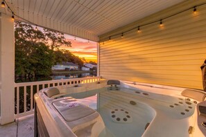 A hot tub on a porch with a view of houses and trees. - Banana Villa - Tropical 4BR Pond-Front Home w/ Private Hot Tub (Walk to Beach) (North Myrtle Beach)