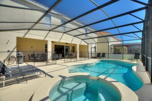 A pool area with lounge chairs, a hot tub, and a covered patio. - Ping-pong | Basketball | Game Room | Resort-Style Pool: Golden Palms Retreat (Davenport)