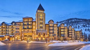 A multi-story hotel with a central tower, snow-covered surroundings, and a paved driveway. -  Ritz- Carlton Club ,Vail, Colorado Cozy 2-bedroom residence,2.5 Bathroom (Vail)
