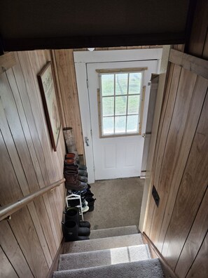 A wooden staircase leading to a white door with a window above it. - Charming 2-bedroom apartment  in Springfield (Springfield)