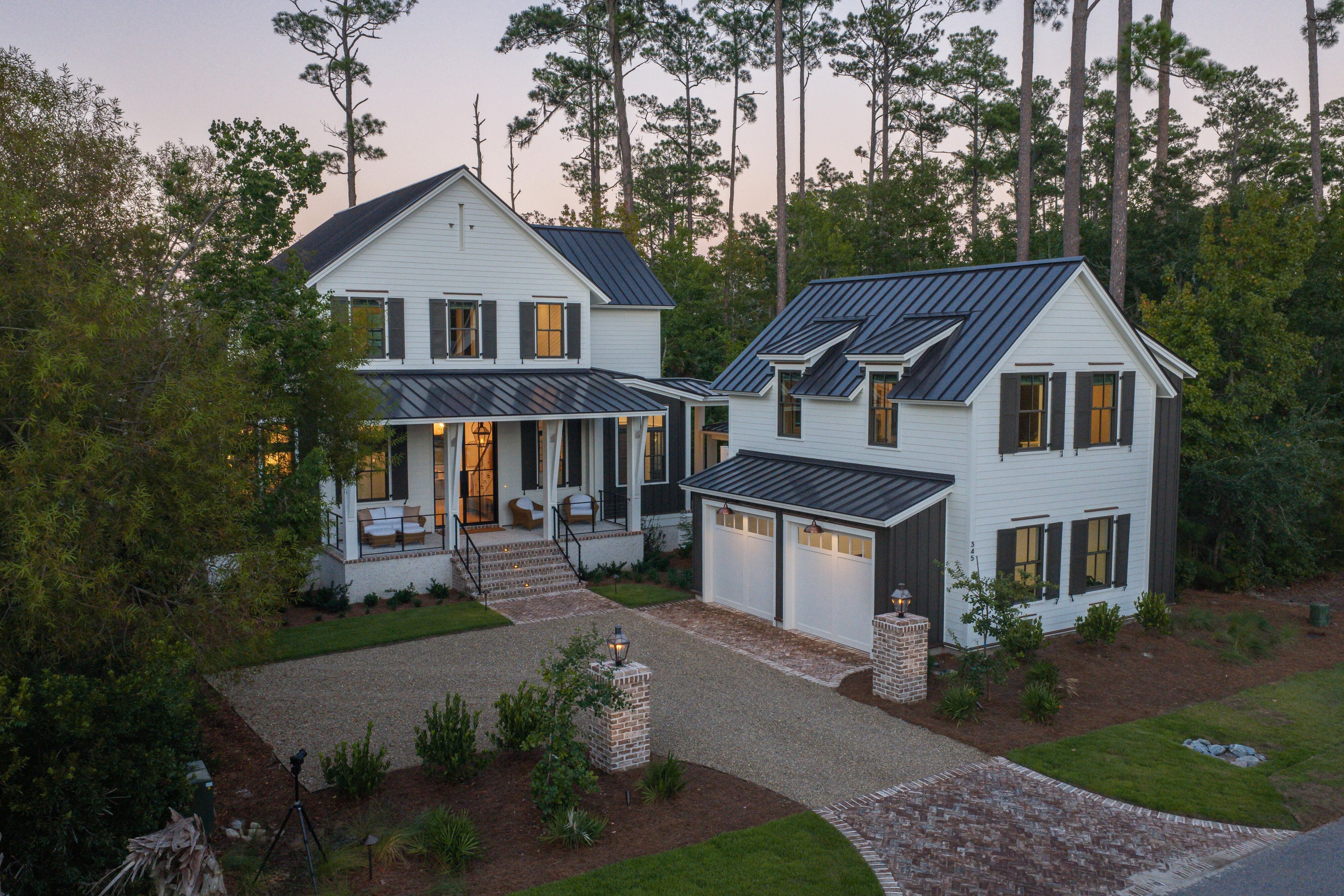 A two-story house with a covered porch and a garage.