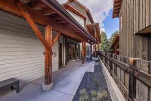 A covered timber walkway runs along the side of the home. | Exterior View - New! Private Hot Tub | Town Center | Sleeps 9 (Big Sky)