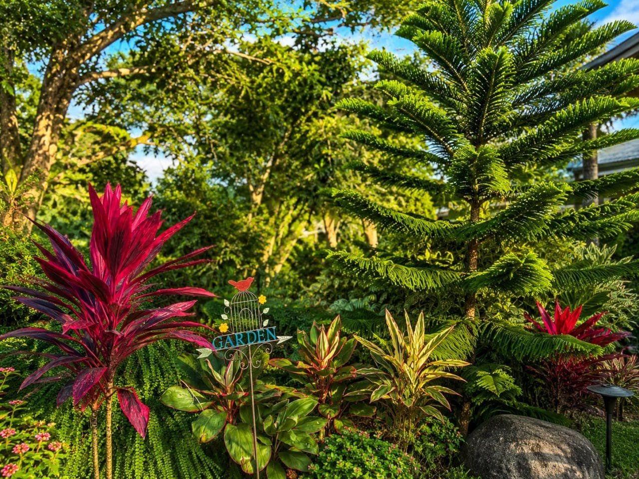A lush garden with a variety of plants and a sign indicating a garden area.