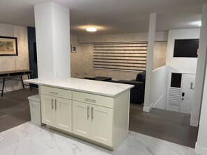 A kitchen with a marble countertop, white cabinets, and a built-in stove. - 3BR-Upper level unit - Fleetwood-10 mins to HWY (Surrey)