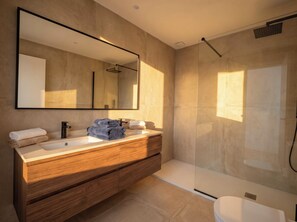 A modern bathroom with a large mirror, a wooden vanity, a glass shower enclosure, and a toilet. - Rocha Golden Cliff by Agsuites com (Praia da Rocha)