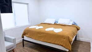 A single bed with a brown bedspread, white pillows, and a white towel folded on it. - Newly Renovated 1BR | Near Beach & Downtown Unit 2 (Hollywood)