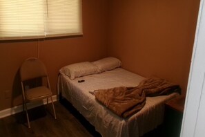 A small, single-bed room with a chair and a blanket on the bed. - 3 bedroom one bathroom in High point N.C. near HPU, (High Point)