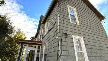 A two-story house with a gabled roof and a front porch.