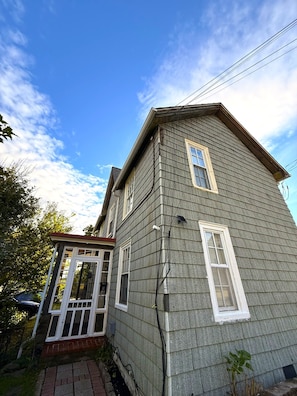 A two-story house with a gabled roof and a front porch. - Cute 1-Bedroom in Heart of Berwyn (Berwyn)