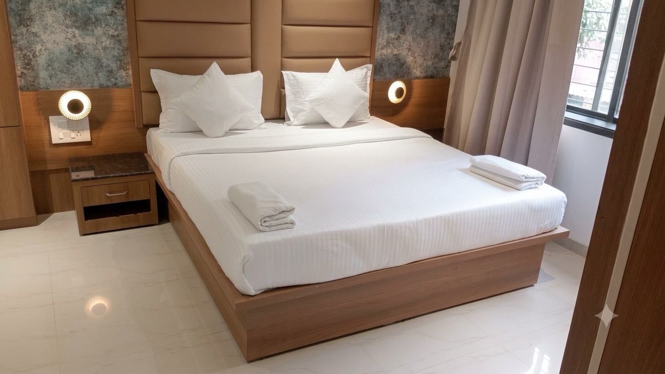 A modern hotel room with a large bed, two bedside tables, and a nightstand.