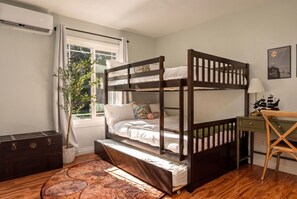 A bunk bed with a desk and chair, a potted plant, and a window with curtains. - Enchanted Stay: Disney, Spa, Theater, Arcade, Playgound (Midway City)