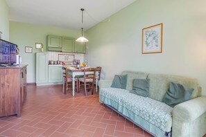 A compact living space with a kitchenette, dining area, and a sofa. - Chianti Site Apt Prato Shared Pool| 4, Castelfiorentino, Italy (Castelfiorentino)