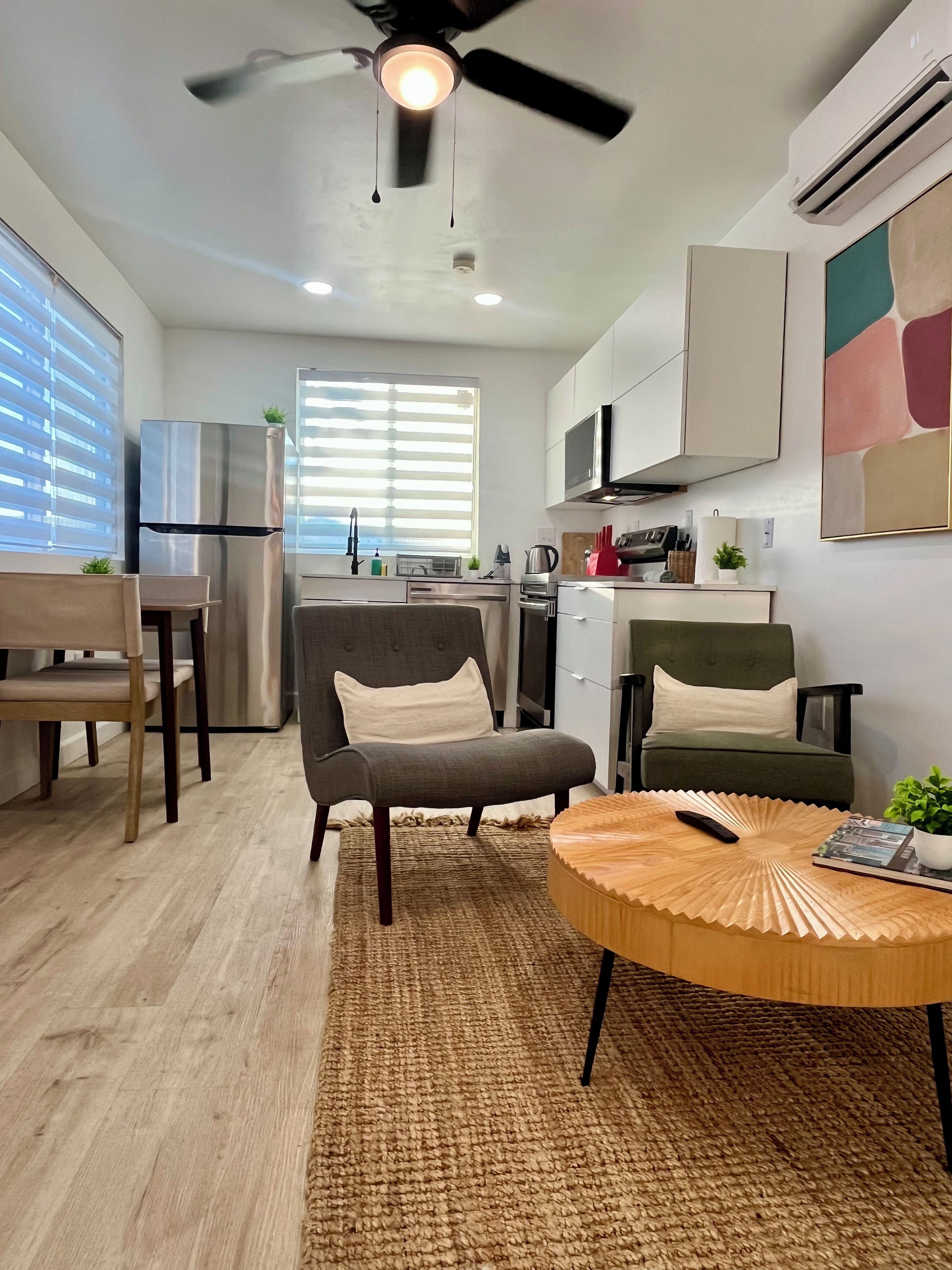 A modern kitchen with a built-in oven, a microwave, and a coffee machine.