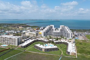 A coastal hotel with multiple buildings, a marina, and a view of the ocean. - Sunchase IV #312 - Beachfront Resort, Pools & Balcony (South Padre Island)