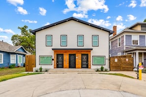 A two-story residential building with a front entrance, a garage, and a driveway. - Stylish Japandi 1BR-Bishop Arts-Nr Downtown Dallas (Dallas)