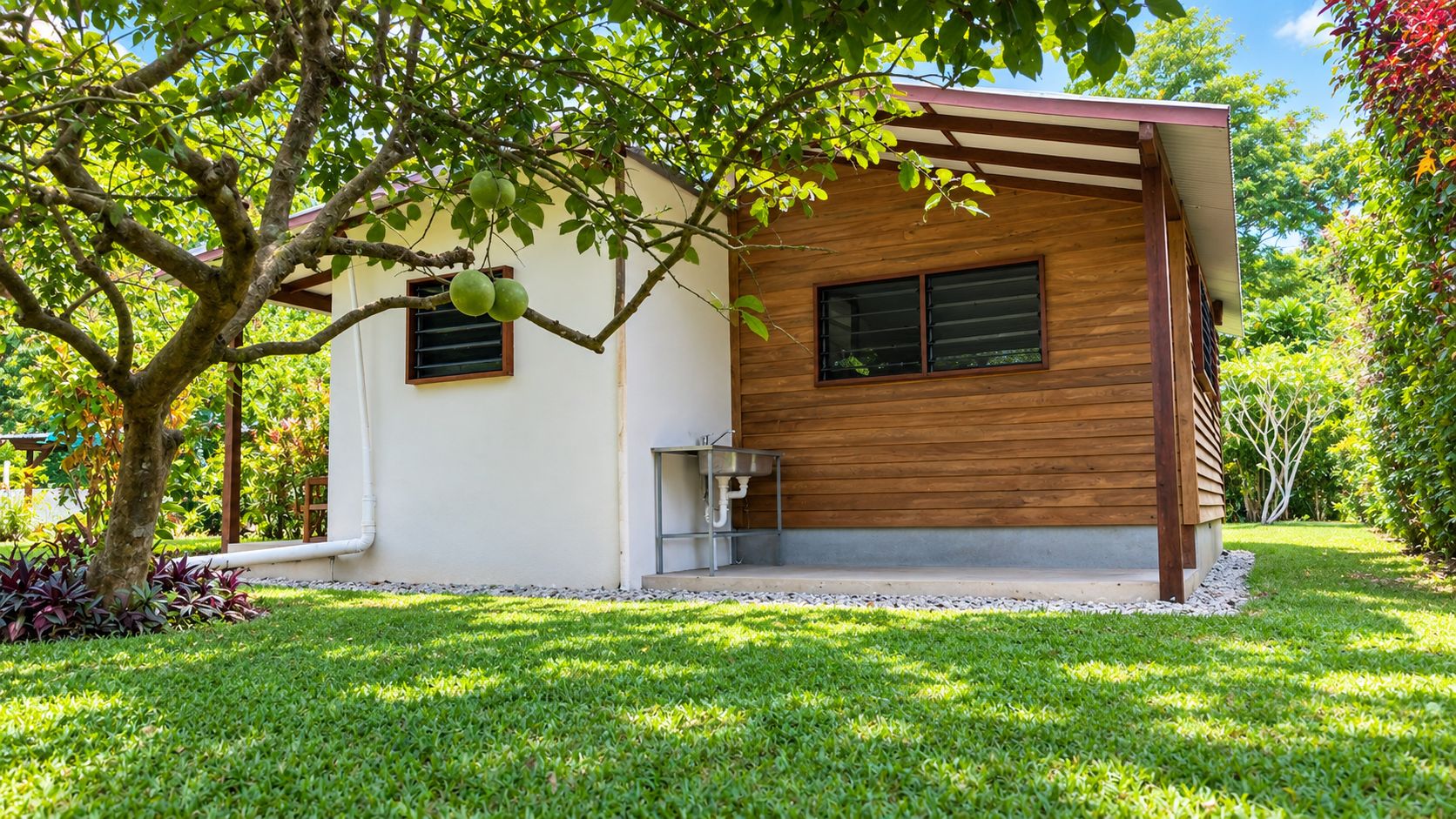 A modern house with a wooden exterior, a small porch, and a well-maintained lawn.