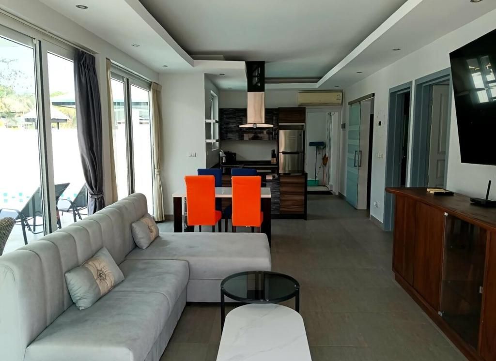 A modern living room with a sofa, a coffee table, and a television.