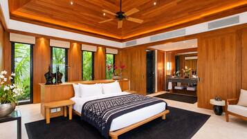 A modern bedroom with a large bed, wooden ceiling, and a view of greenery outside.